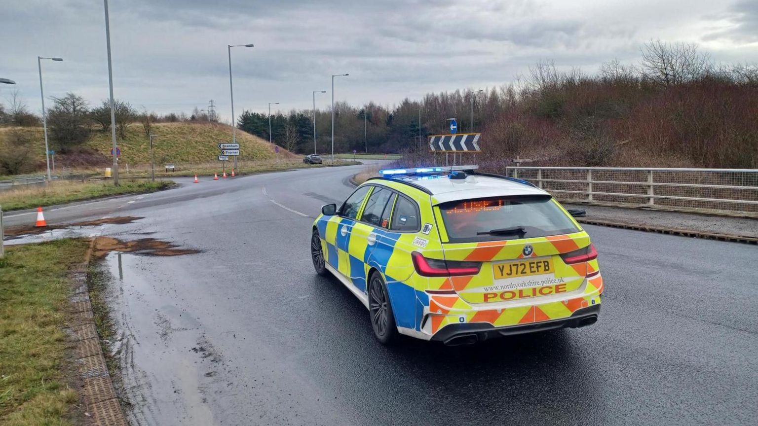 Police at the scene of an oil spillage at the junction of the A1(M) and A64