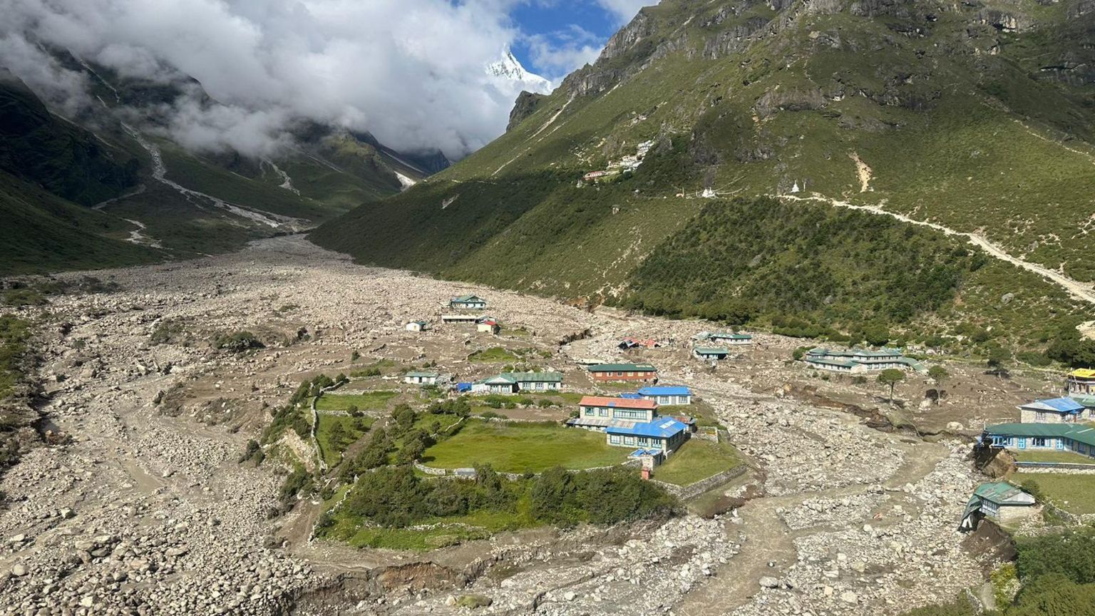 Aerial view of a flood-affected village in a Himalayan valley