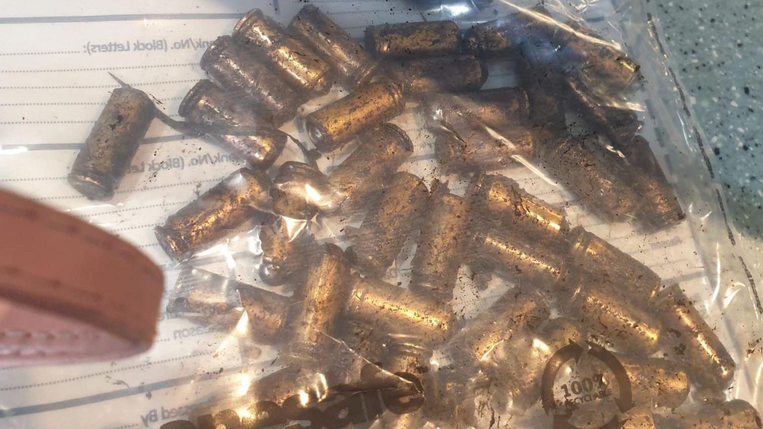 Bullets in a clear plastic bag after being pulled out of a canal