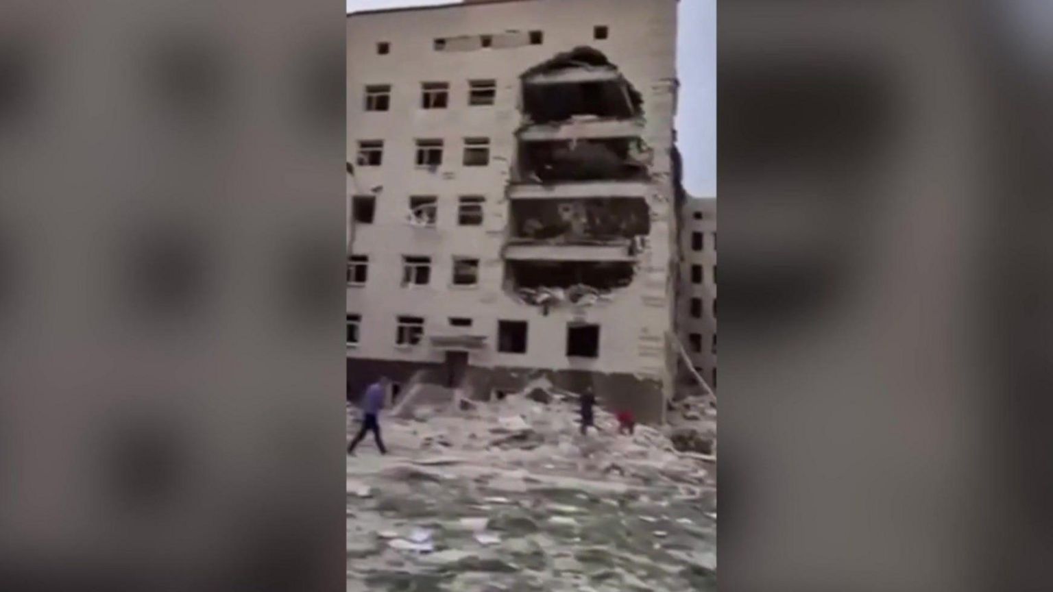 A screenshot from a clip filmed on a mobile phone of a damaged building in Poltava. There are bars either side of the image to fit the aspect ratio.