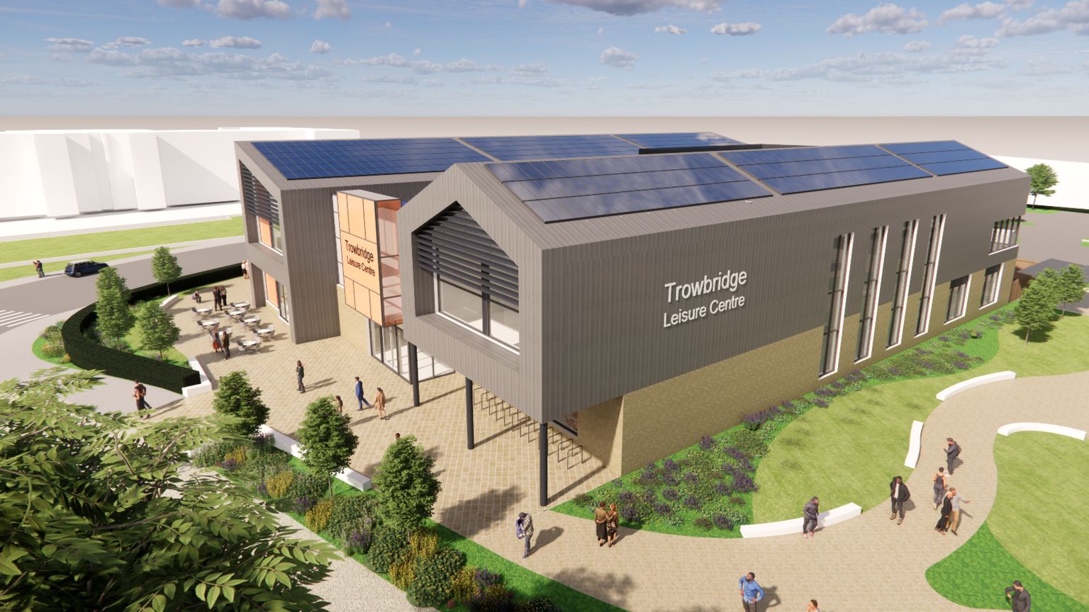 An artist impression of the new leisure centre in Trowbridge. It includes trees and a grey facade and solar panels on the roof.