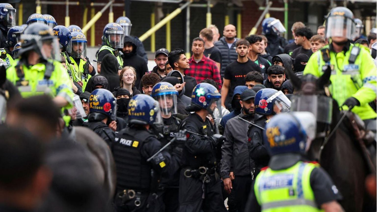 Police officers stand guard during an anti-immigration protest in Bolton