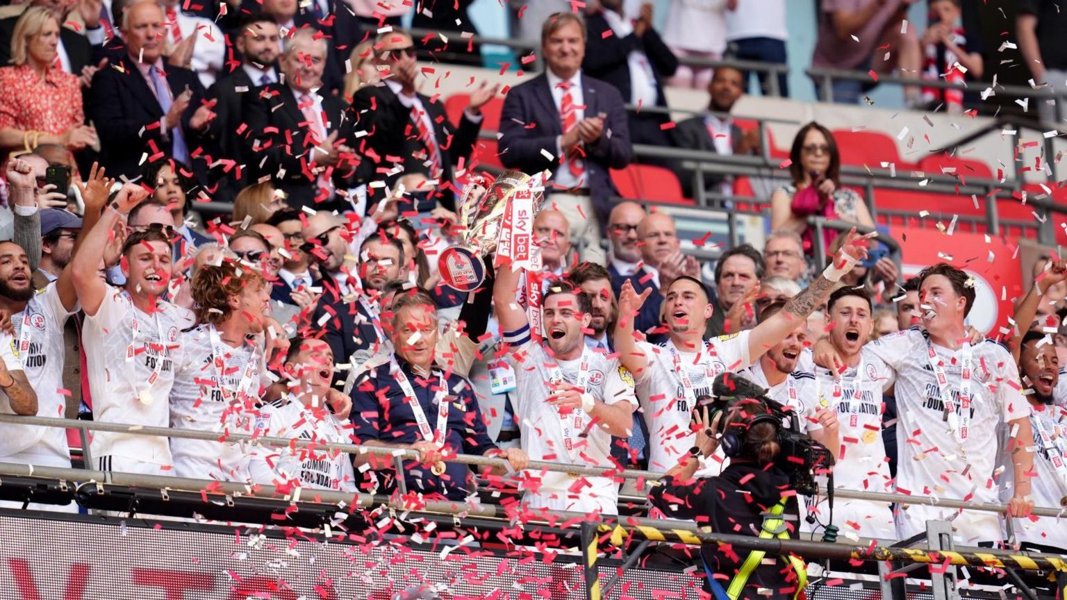 Crawley Town lifting the promotion trophy at Wembley Stadium