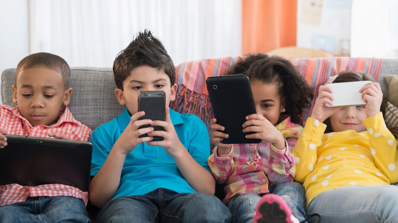 Children using phones and tablets