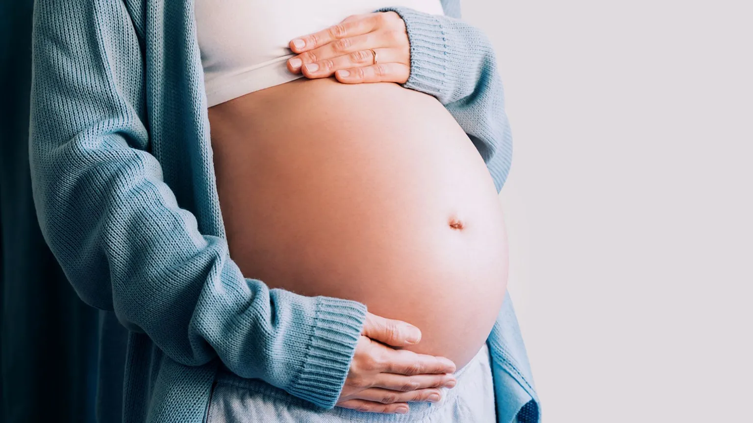 Getty Images A stock image of an expectant mother touching her baby bump.