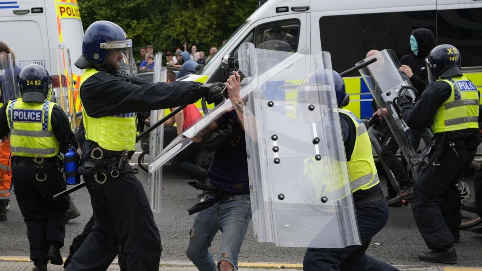 Police officers with protesters as trouble flares during an anti-immigration demonstration outside the Holiday Inn Express in Rotherham, South Yorkshire, on Sunday August 4,