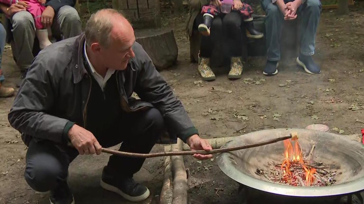 Ed Davey toasting marshmallows at a forest school in Surrey