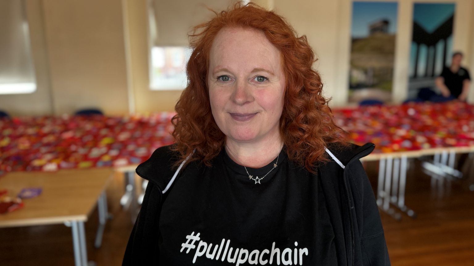 Dr Sarah Martin-Denham in a black t-shirt with the blanket in the background