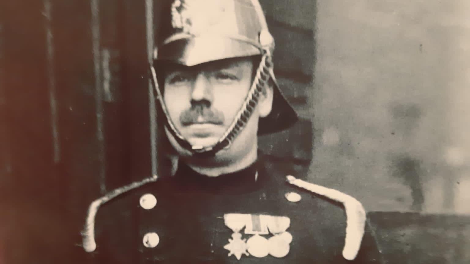 John Singleton dressed in full uniform wearing three medals on his chest