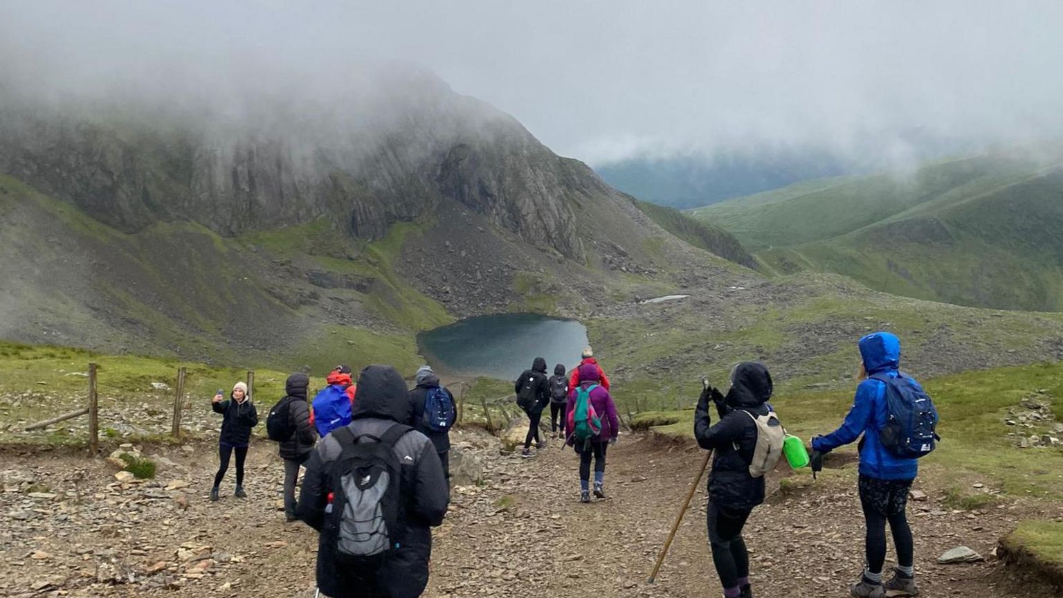Climbers taking part in the Snowdon Sunrie Trek with Snowdon in front of them