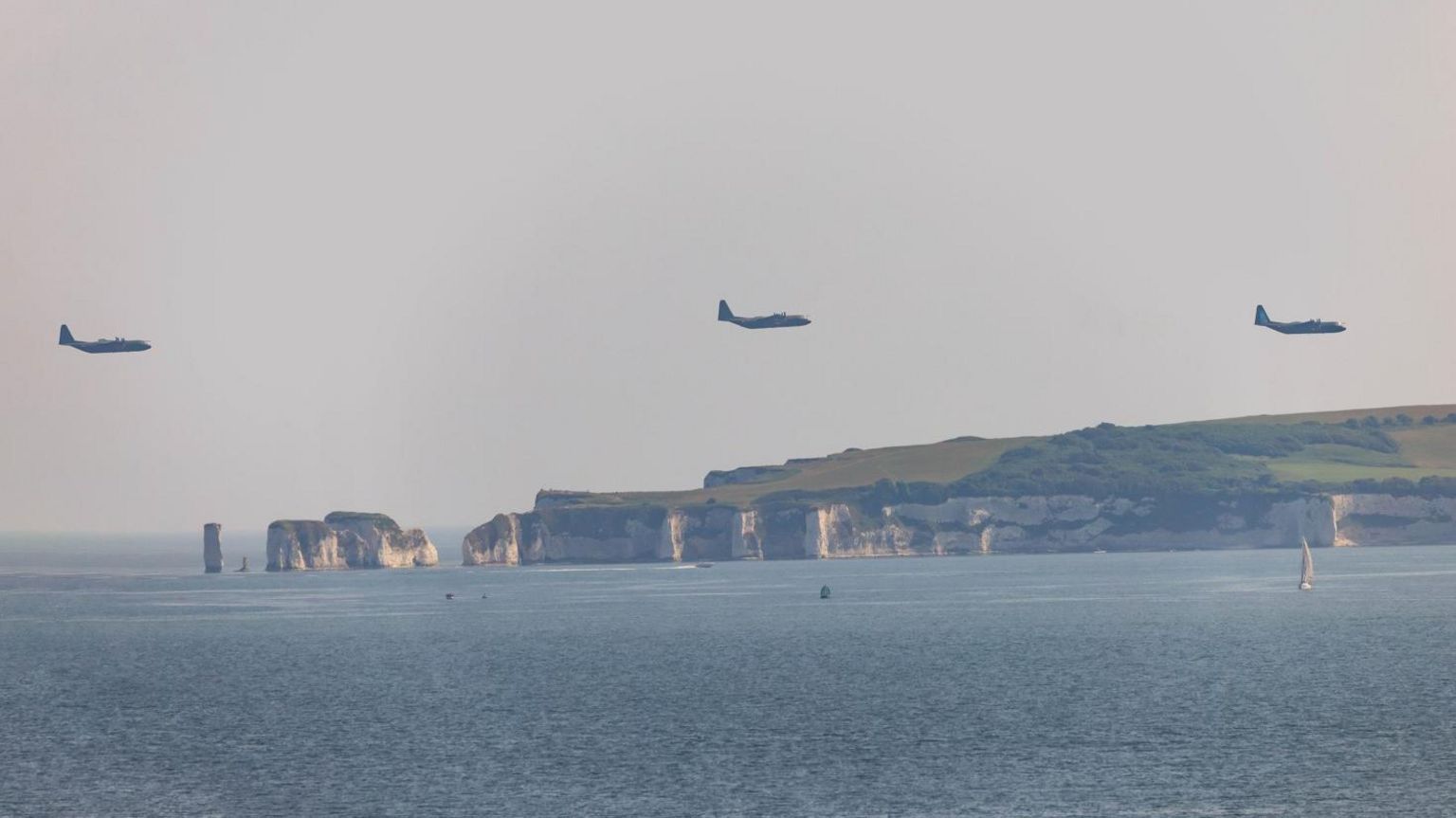 Three Hercules aircraft flying over Old Harry Rocks