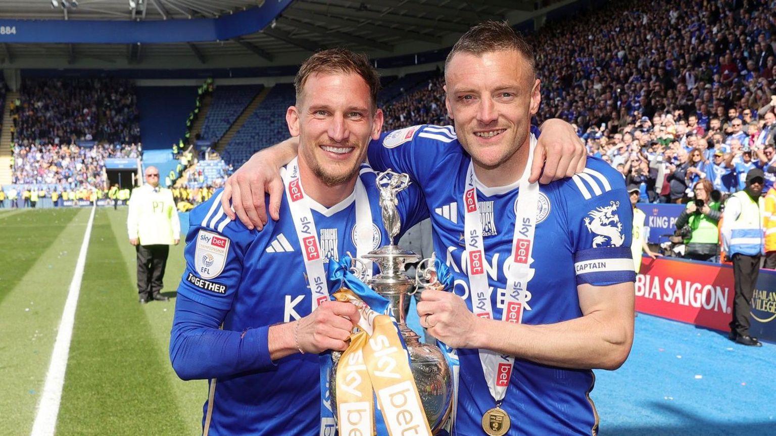 Marc Albrighton (left) and Jamie Vardy hold the Championship trophy at the King Power Stadium