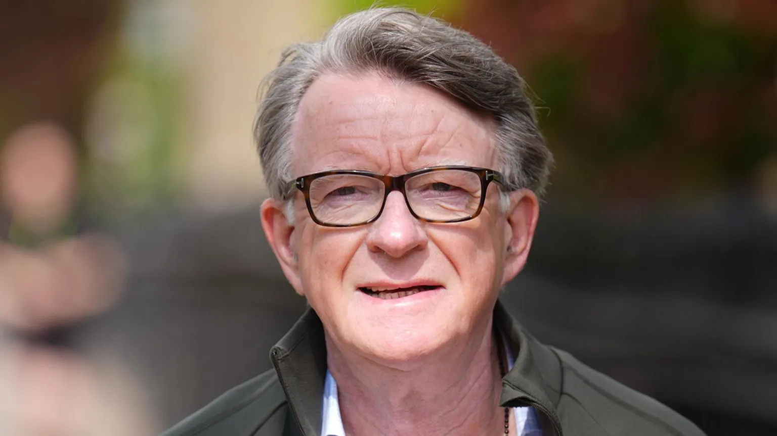 PA Media Peter Mandelson has short greying hair and wears dark glasses. He wears a shirt, grey jacket and appears to be outside
