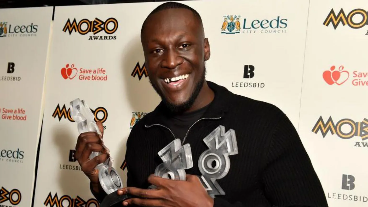 Getty Images Stormzy backstage smiling with Mobo awards