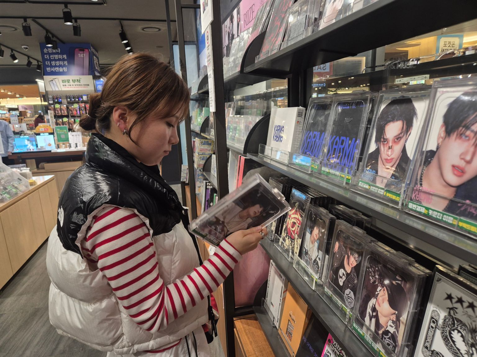 姜圭里在首尔一家音乐商店浏览韩国流行音乐专辑。