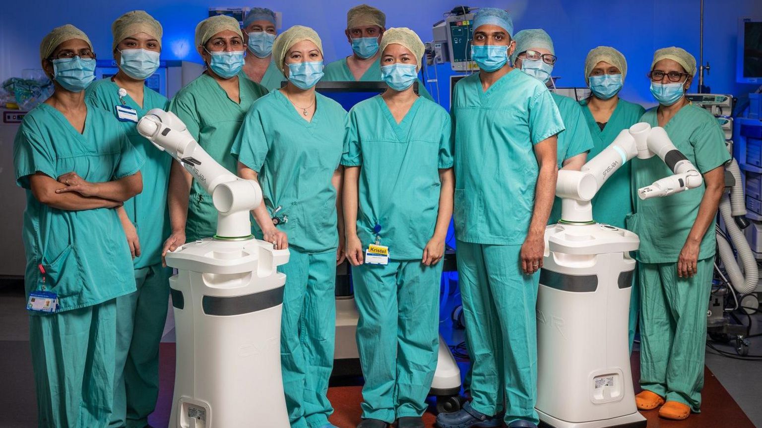 A group of surgeons with two robotic arms
