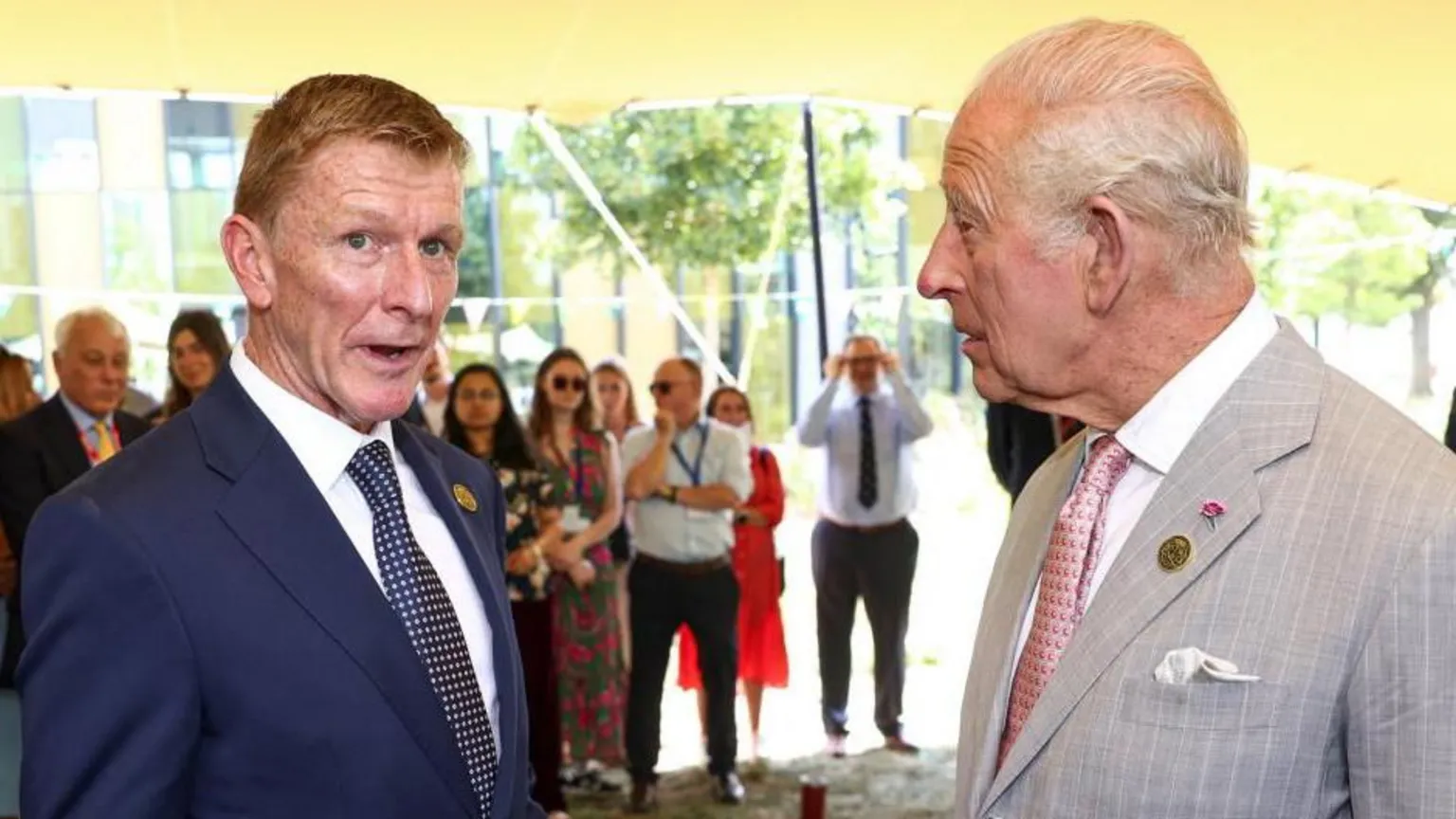 Reuters Tim: Peake and King Charles stand next to each other talking. Both men are wearing suits