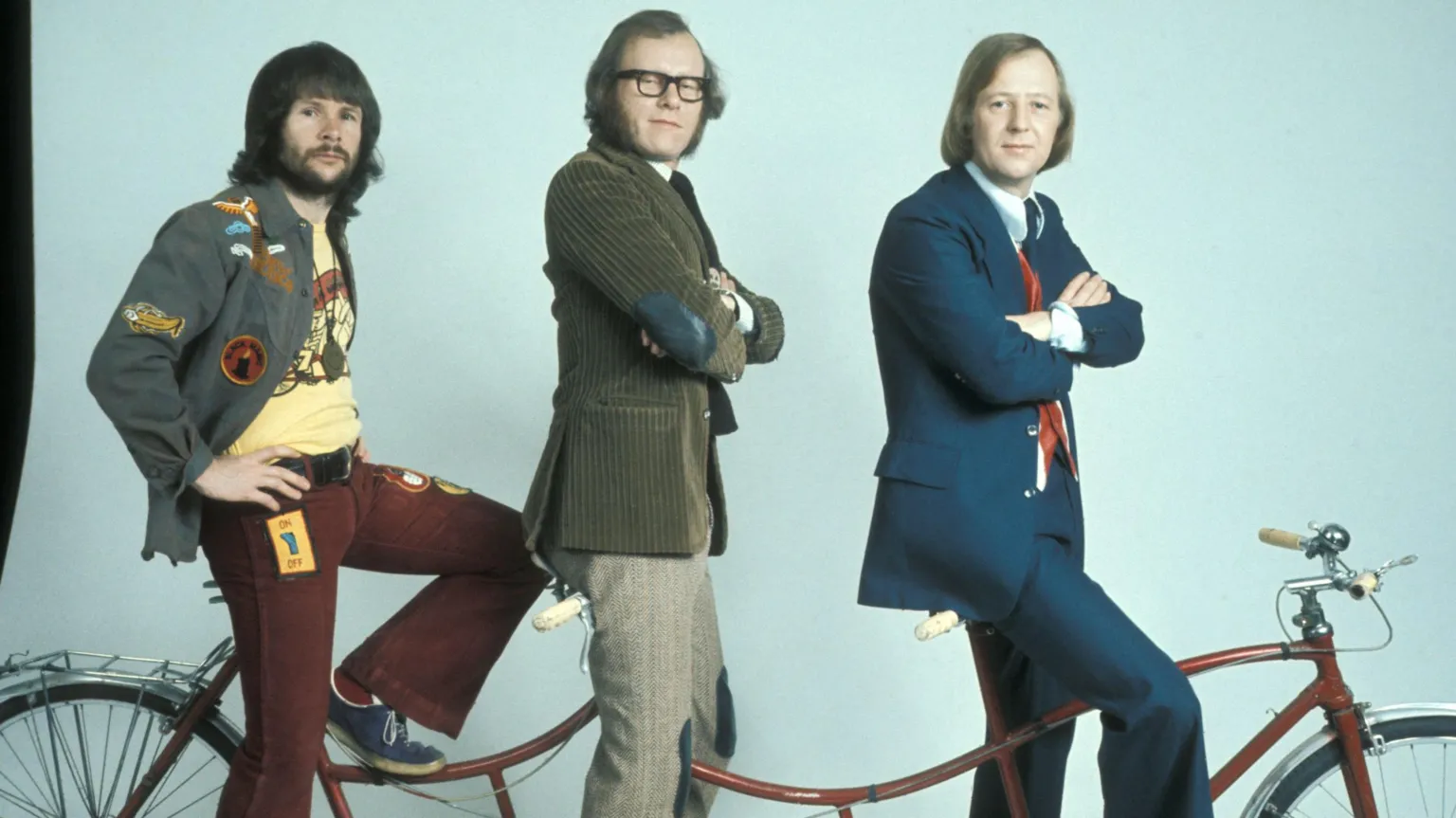 The Goodies on their 'trandem' bicycle. Bill Oddie is at the rear, Graeme Garden is in the centre and Tim Brooke-Taylor is at the handlebars