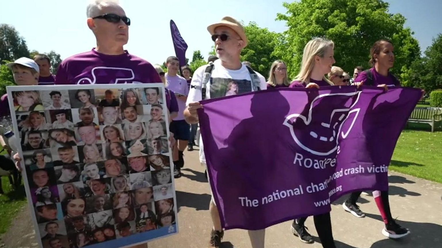 Family members walking carrying banners and montage images of young car crash victims