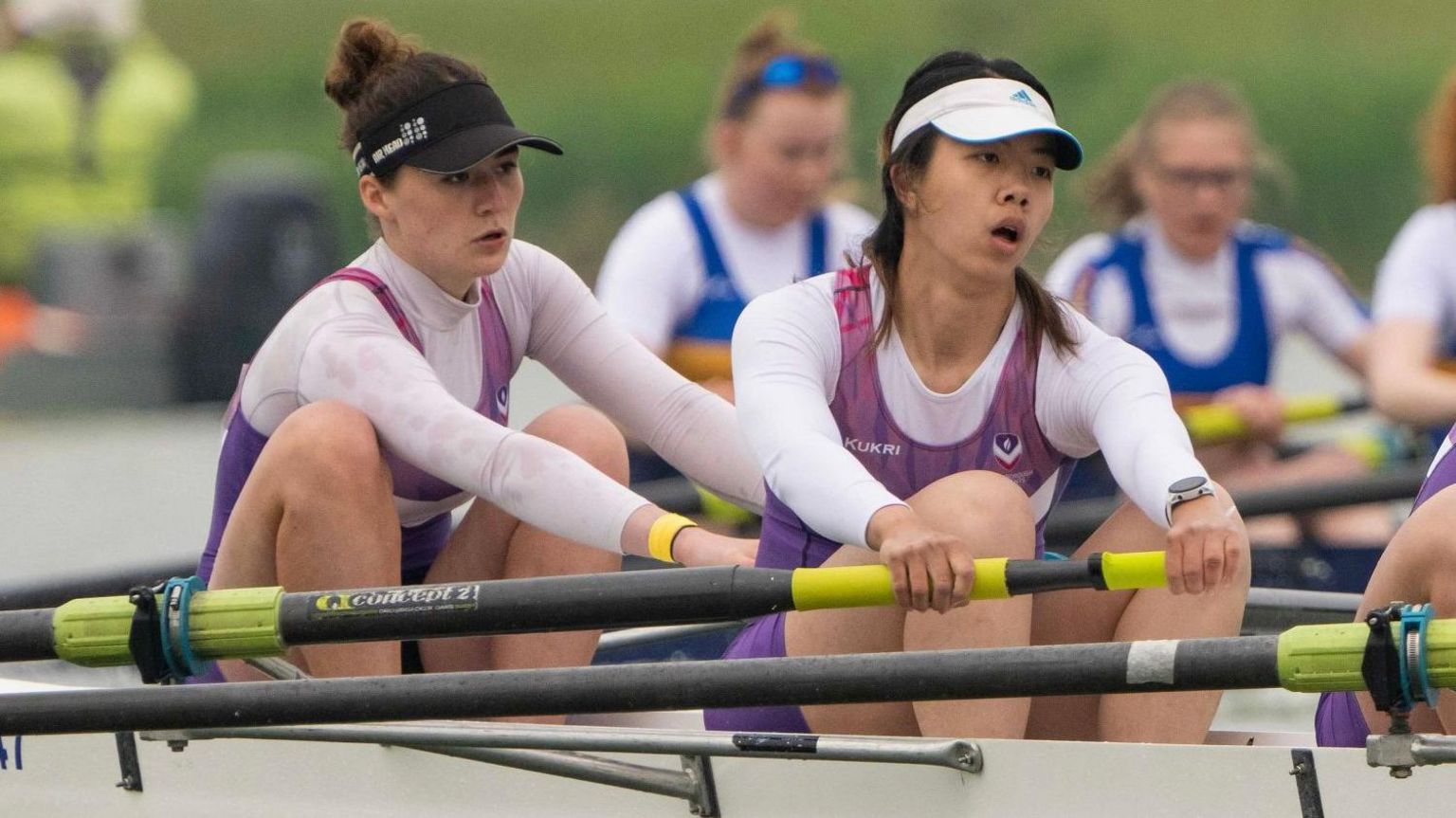 Women's team rowing in competition on river