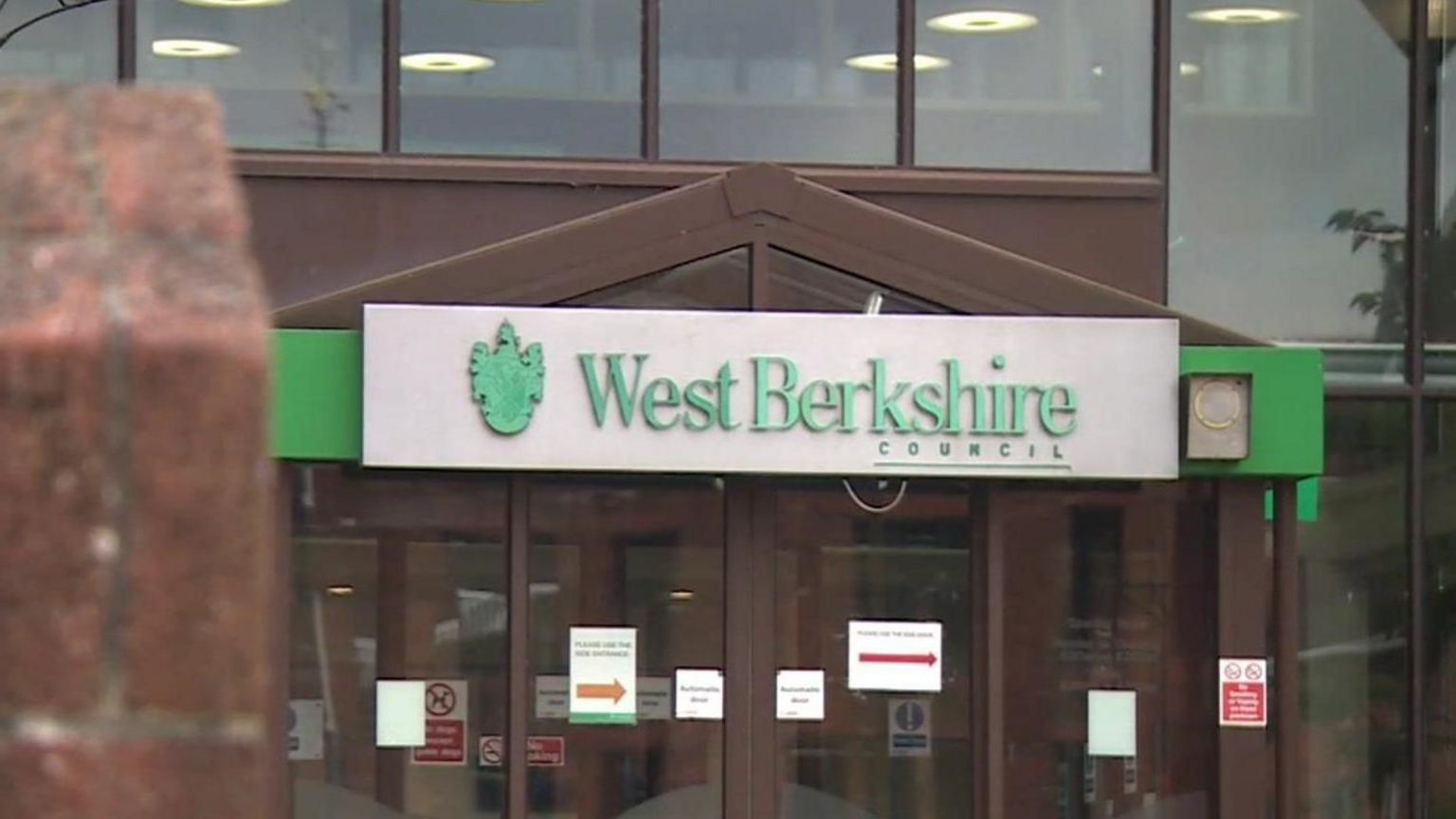 The front of West Berkshire Council's headquarters - with the authority's name in green and white over the entrance doors