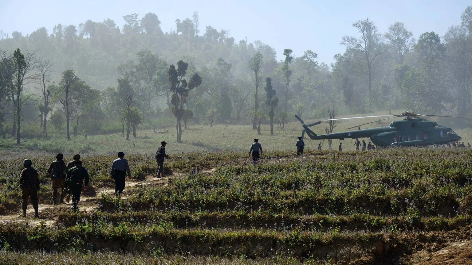 Getty Images In this photo taken on January 24, 2026, soldiers and police walk towards a military Mi-17 helicopter transporting a military-organised press tour at a drug production site southwest of Mongyai, northern Shan State, that was captured by the Myanmar military.