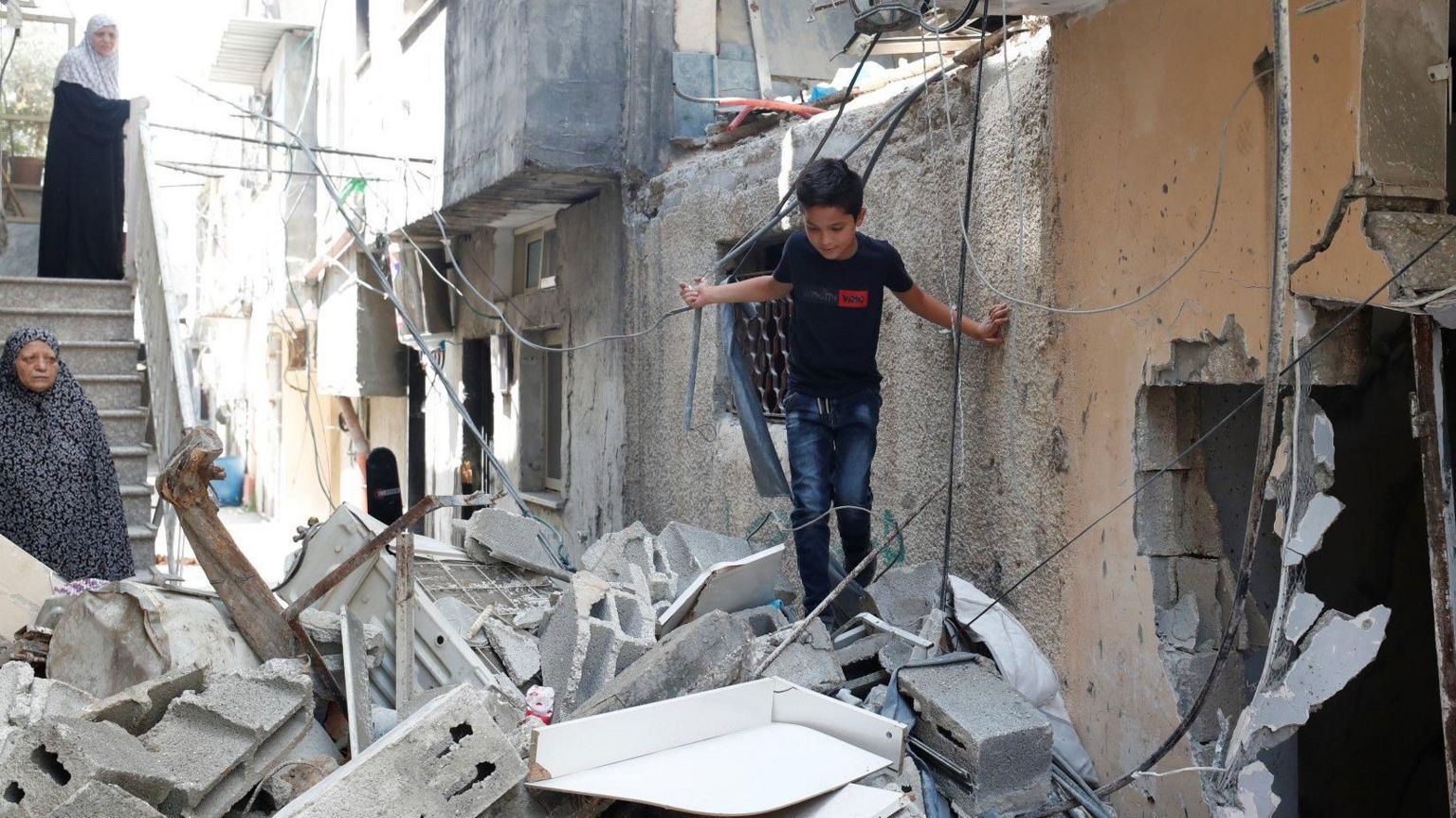 A boy stands on top of rubble from buildings damaged during a two-day Israeli army operation in Tulkarm, in the occupied West Bank (30 August 2024)