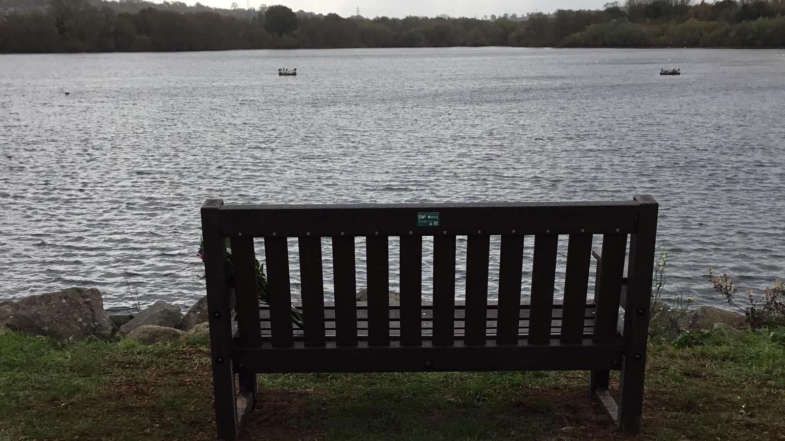 Wooden bench in foreground, 