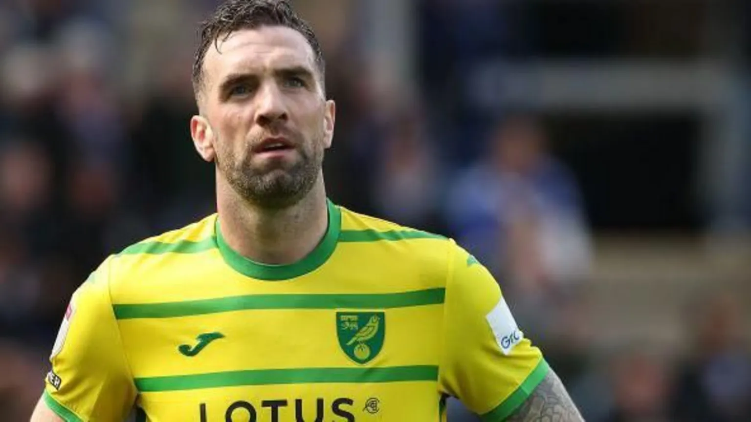 Getty Images Shane Duffy looks upwards dressed in a yellow and green football shirt 