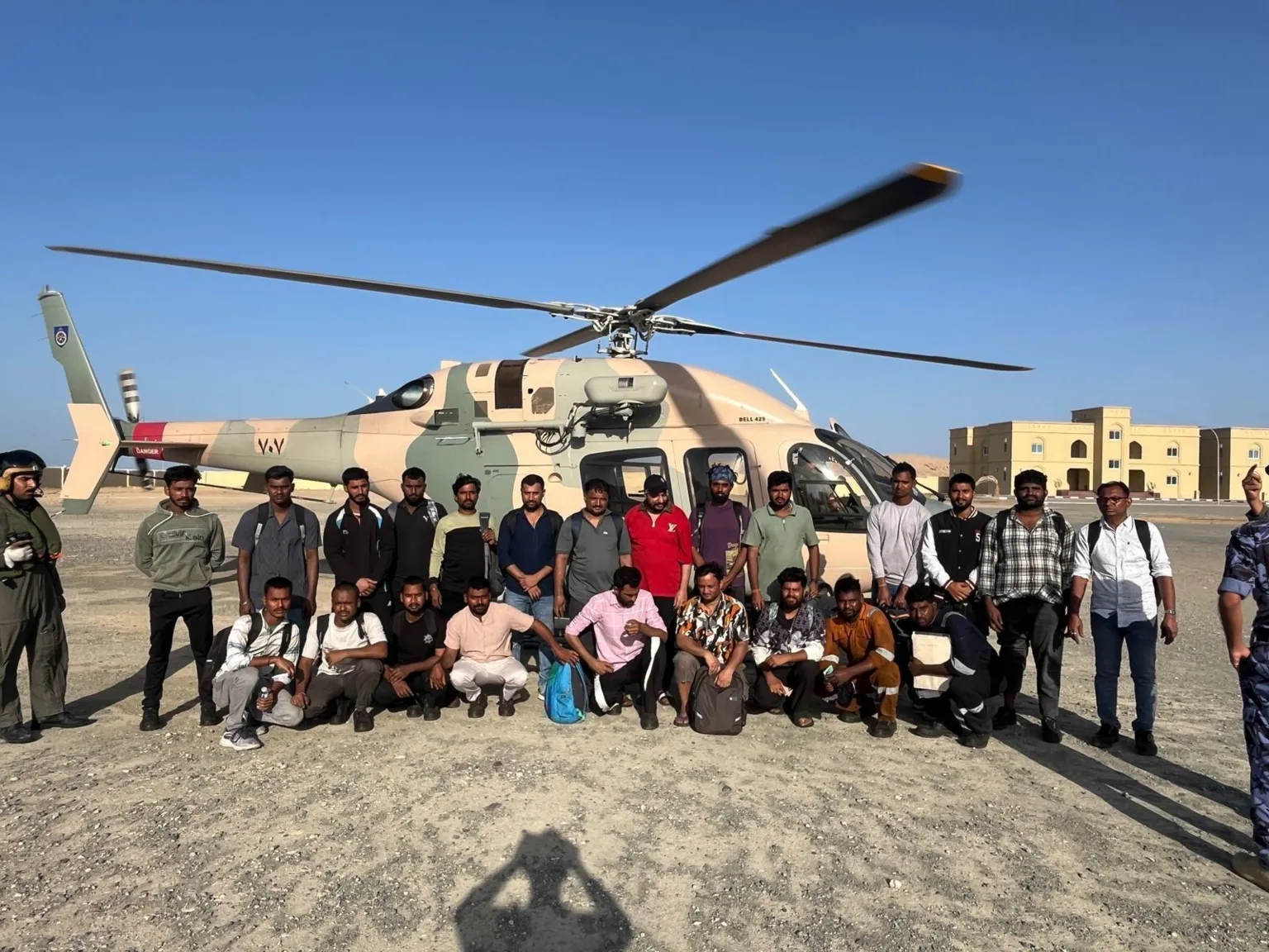 FSUI A group of men standing in front of a helicopter