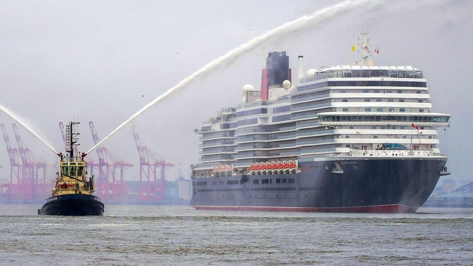 Cunard cruise ship the Queen Anne is escorted by a tug boat on the River Mersey