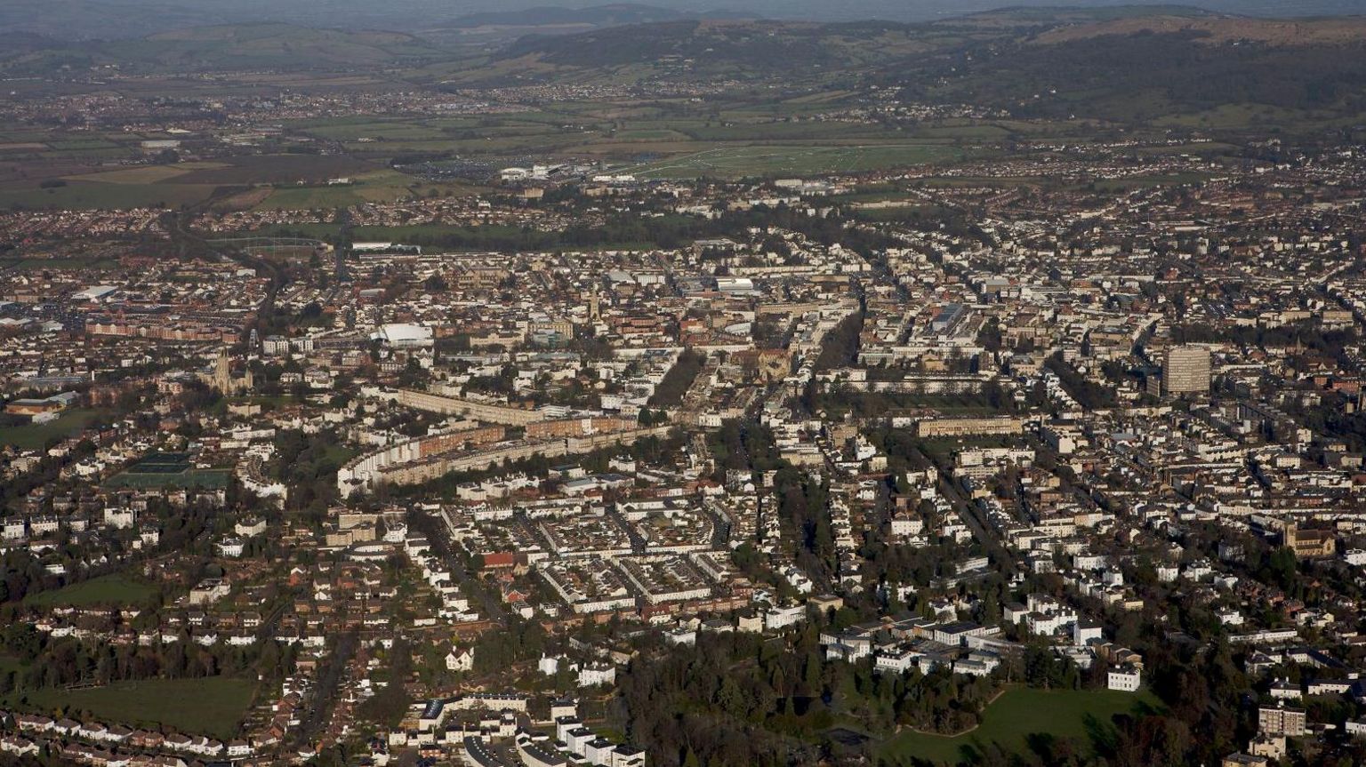 An aerial shot of Cheltenham showing housing estates and the town centre