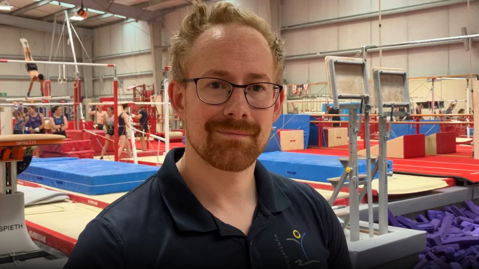 James Barley, deputy head at Huntingdon Gymnastics Club, stood in front of club equipment