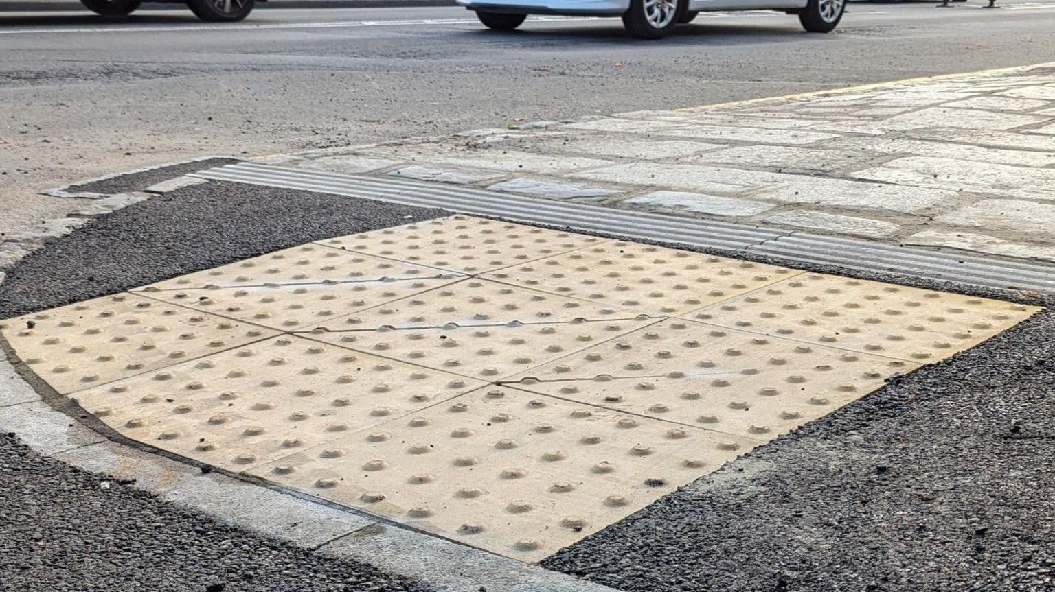 Drop kerb and tactile paving on a pavement edge