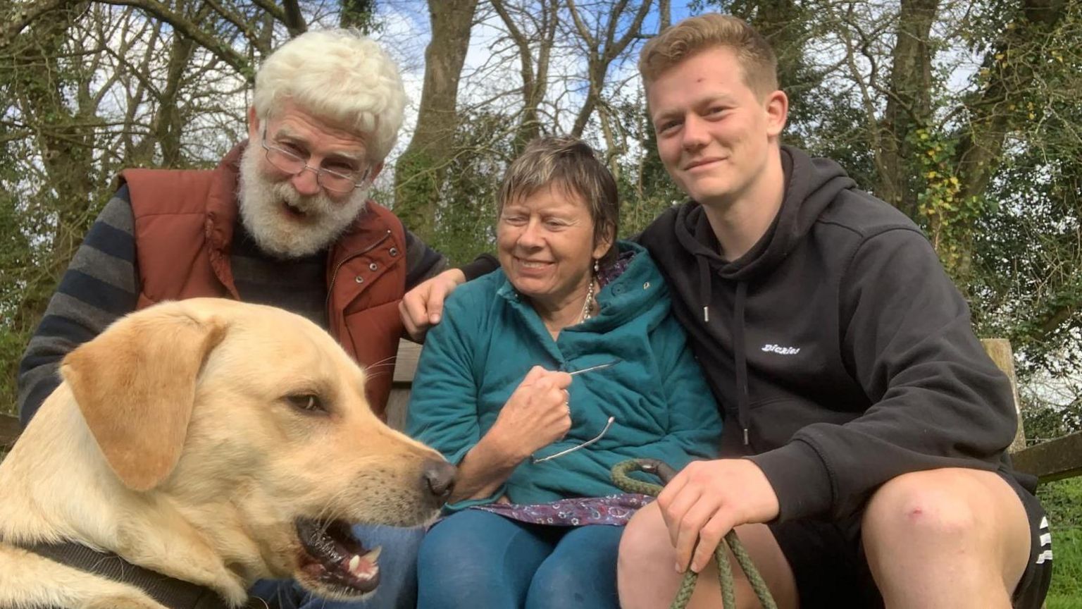 Alex Welford with his parents and their family dog