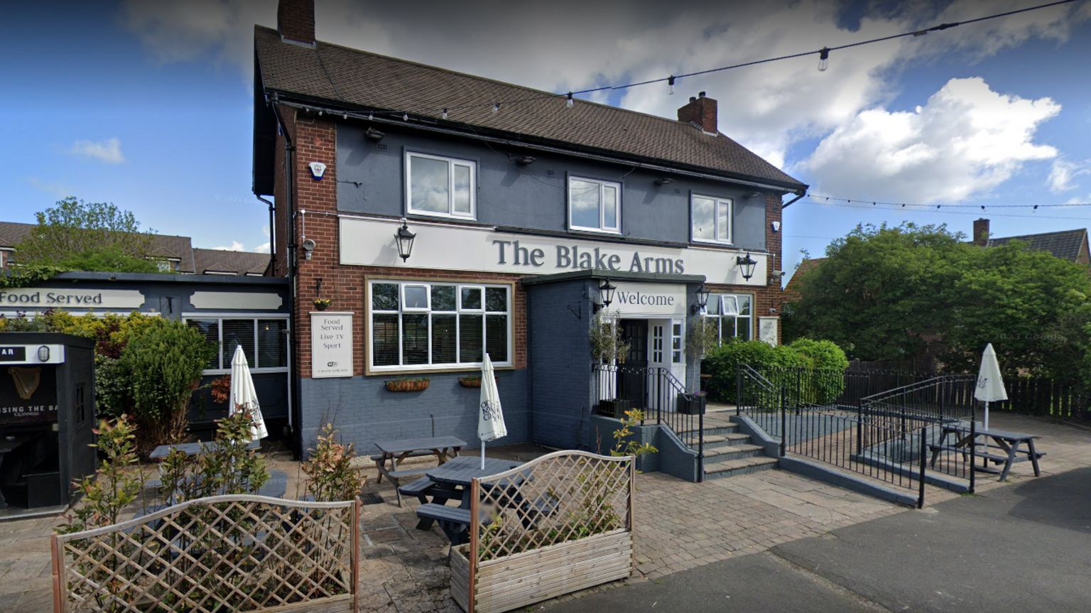A picture of the Blake Arms in Seghill a squre building with a grey front