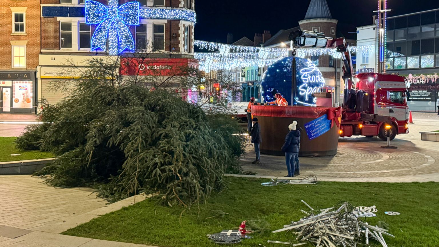 Passersby look on as the tree is cut down on Stockton's High Street