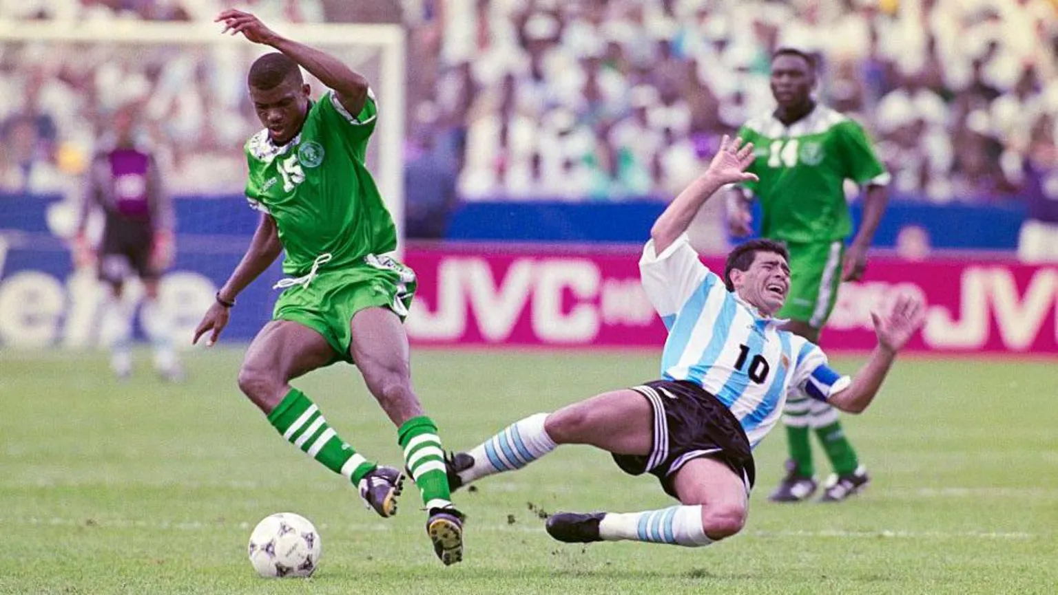 Getty Images  Diego Maradona, playing for the Argentina Men's football team against Nigeria in 1994 in mid air falling to the ground following a challenge.