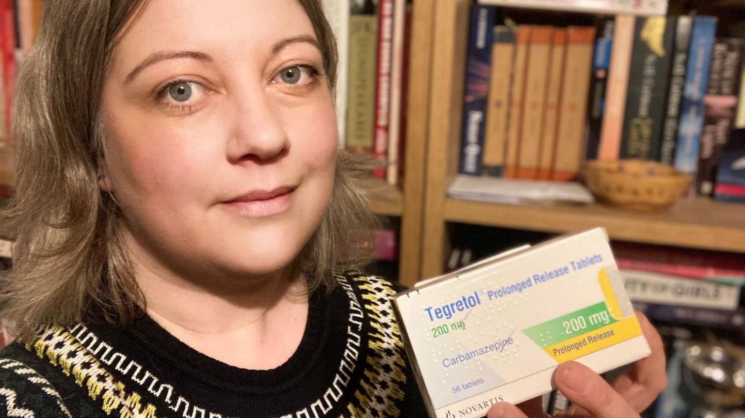 Hannah Hiles holds up the epilepsy drug she takes