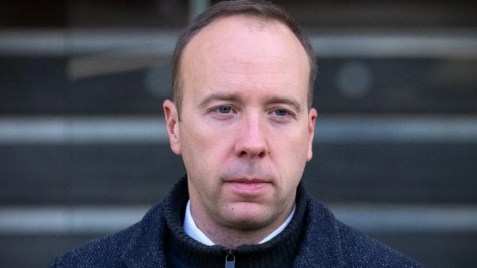 Getty Images Former Health Secretary Matt Hancock looks pensive as he leaves the Covid Inquiry after giving evidence. He wears a white shirt, black zip up sweater and a grey jacket.