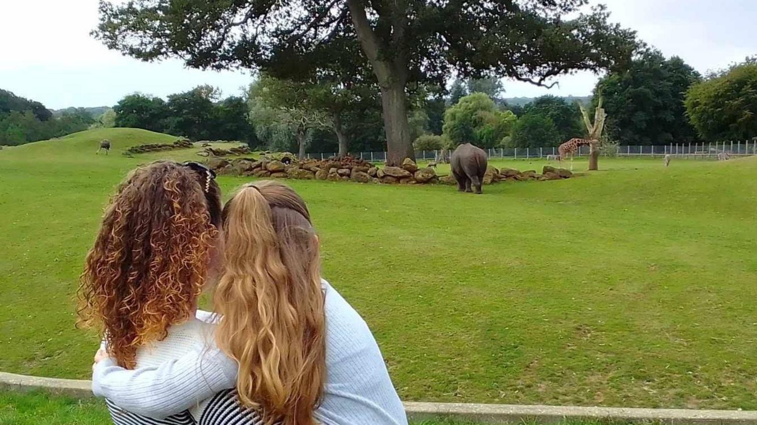 Mum and daughter admiring rhinos at a safari park