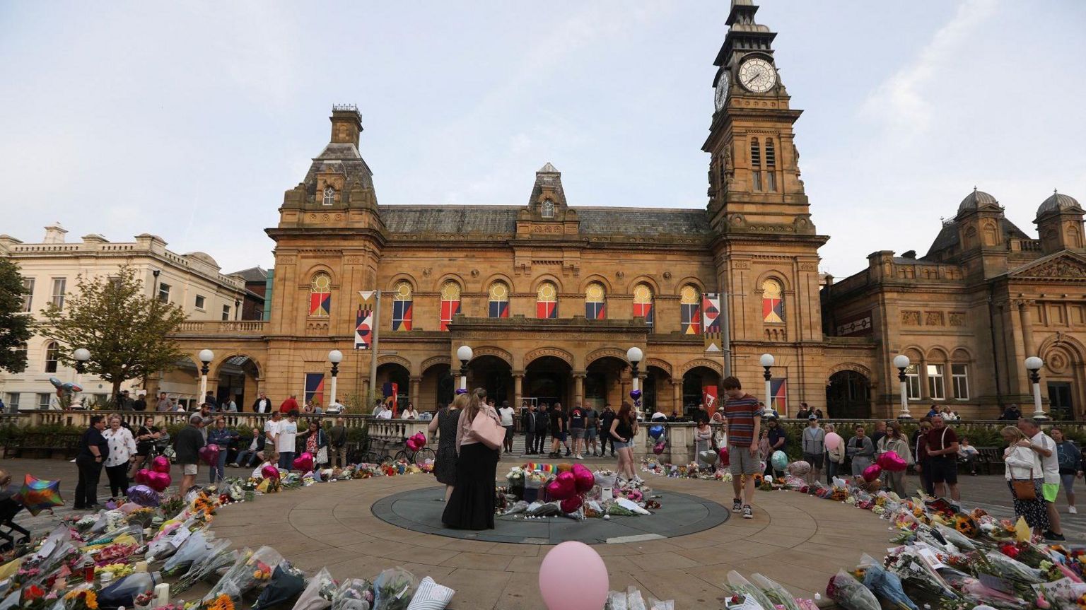 People look at tributes outside The Atkinson