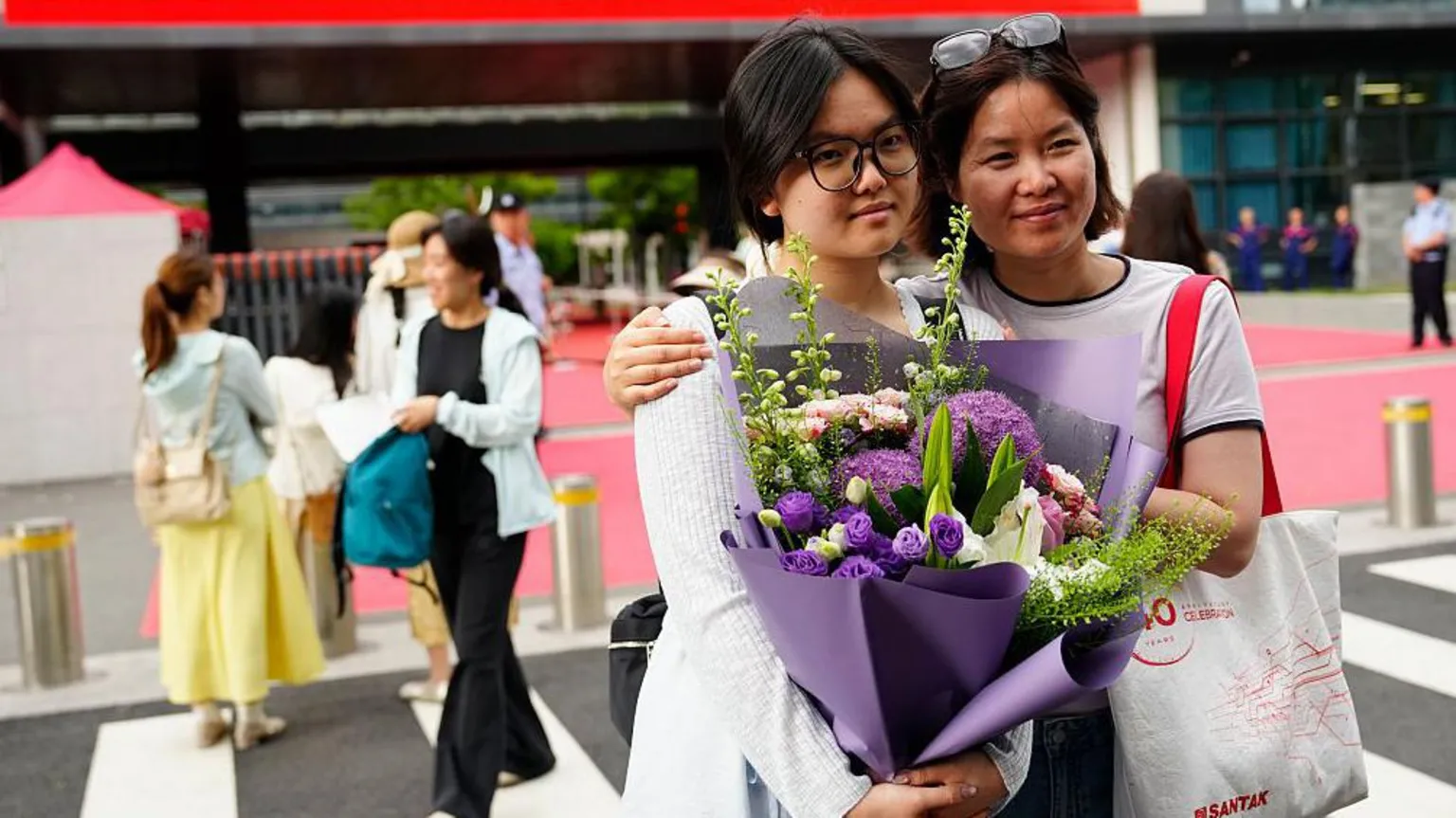 Getty Images A mother hugs her daughter for a commemorative photo, wishing her good grades on June 9, 2026 in Beijing, China.