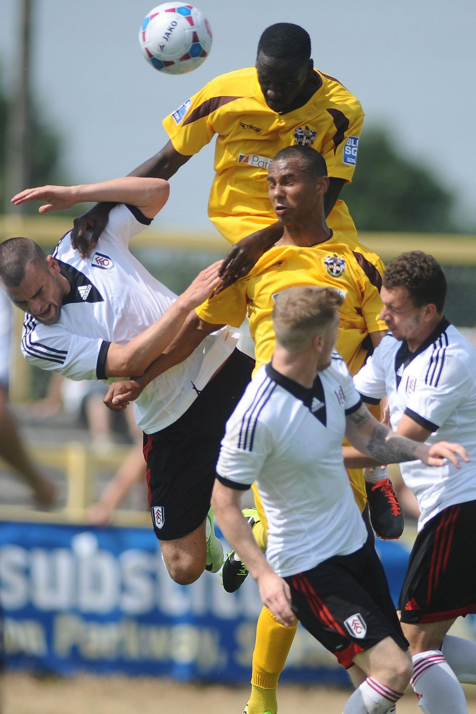 Swaibu wins a header while playing for Sutton United against Fulham