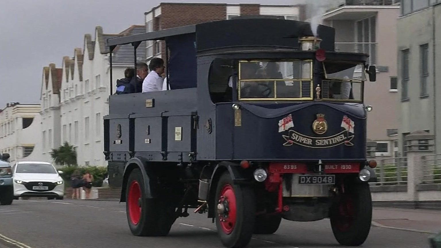 A vintage steam lorry driving along a street