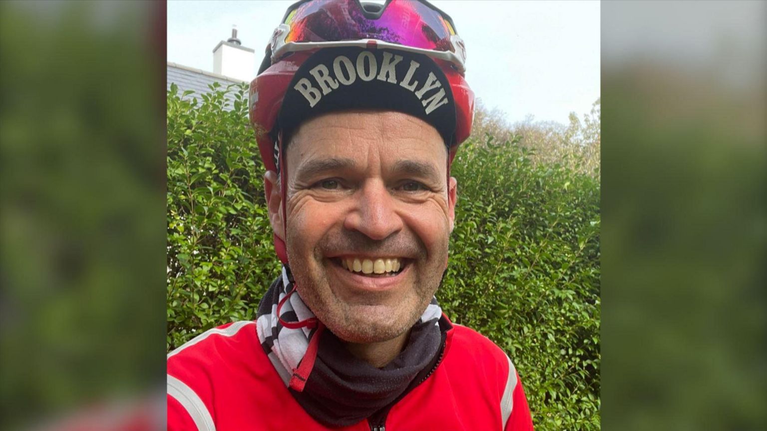 A smiling man in cycling gear
