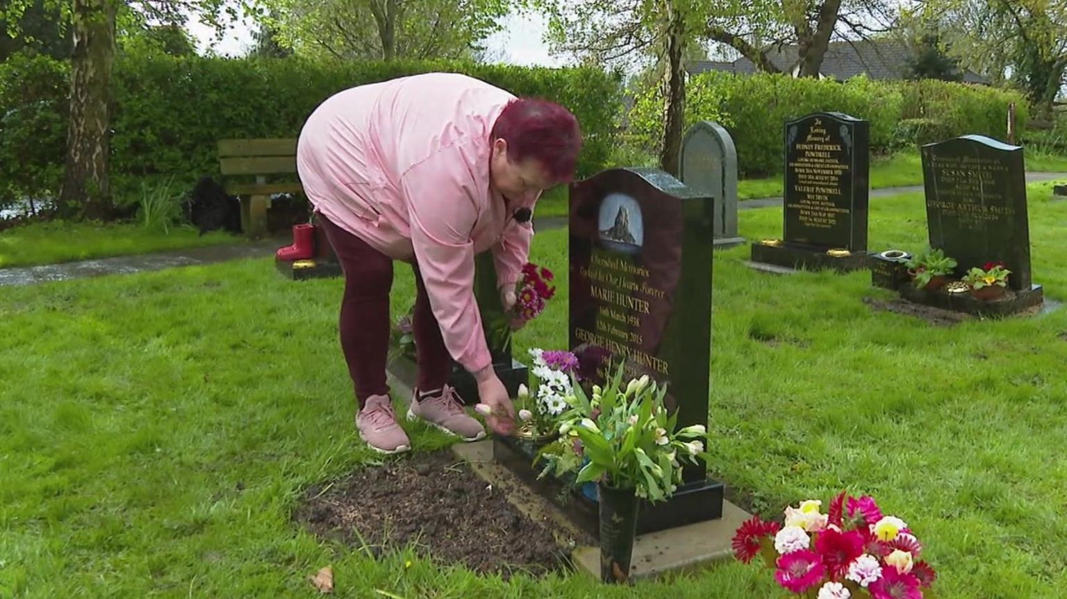 Anita Jewitt-Holder tends to her parents grave