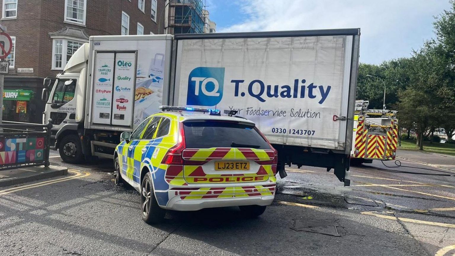 A crash between a police car and a lorry