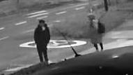 Black and white CCTV still of a man and a woman