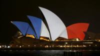 The blue, white and red colours of France's national flag are projected onto the sails of Sydney's Opera House in Australia, 14 November 2015